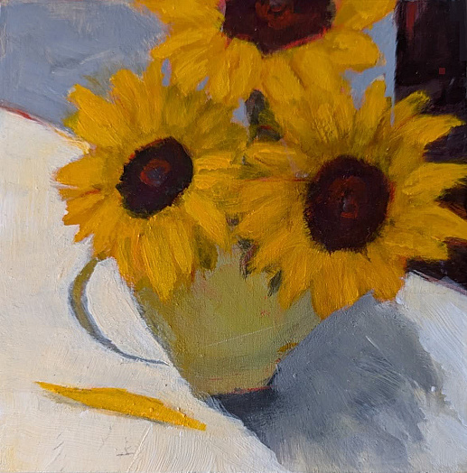 sunflowers in pale green vase on white table